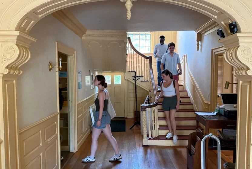 People on a walking tour, viewing the interior of a historic home